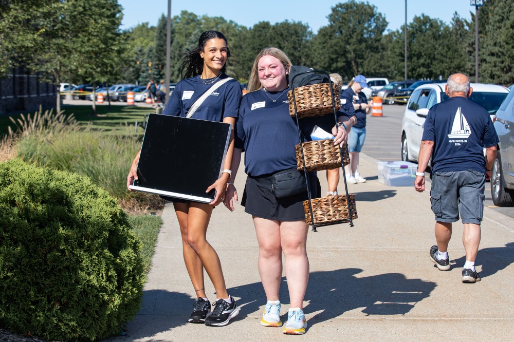 2 Alumna carrying new lakers� supplies, posing and smiling at camera